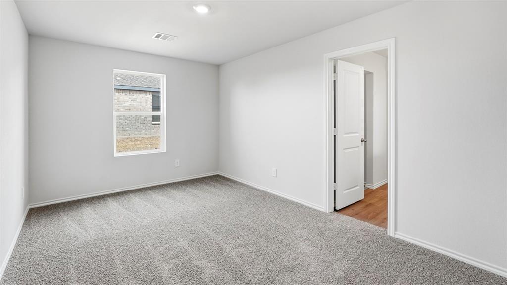 3535 Spring Time Street Forney, TX 75126 - Photo 11 of 23 Room featuring light gray walls, gray patterned carpeting, and white trim