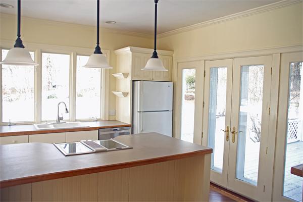 212 South Road Pepperell, MA 01463 - Photo 10 of 22 a kitchen with kitchen island a counter top space wooden floor and a large window