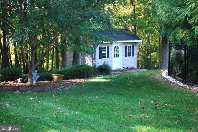 607 Havenhill Road Edgewater, MD 21037 - Photo 8 of 29 a front view of a house with a yard and trees