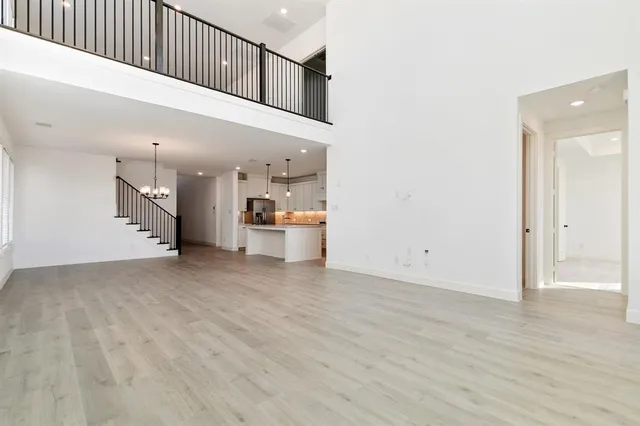 a view of a kitchen with a sink and a refrigerator