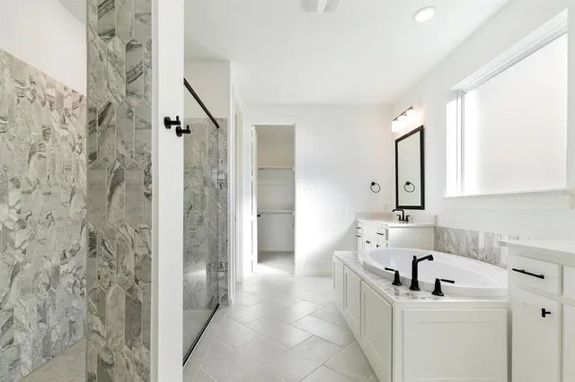 a bathroom with a sink a mirror and a bathtub