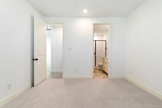 an empty room with wooden floor and mirror