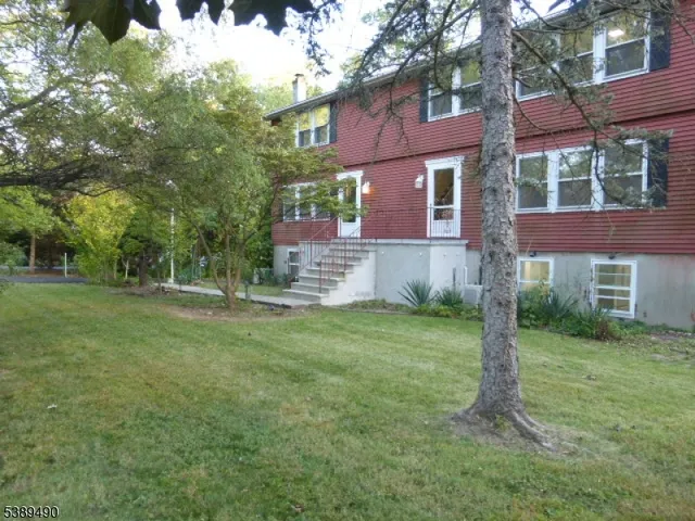 a backyard of a house with table and chairs
