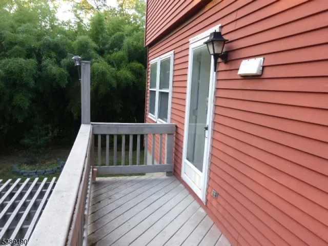 a view of balcony with wooden floor and fence