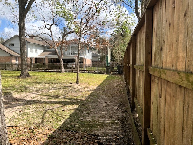 8639 Cedarbrake Drive Spring Valley Village, TX 77055 - Photo 25 of 26 Explore the spacious, sun-dappled yard, perfect for relaxation or play, framed by a charming wooden fence and mature trees.