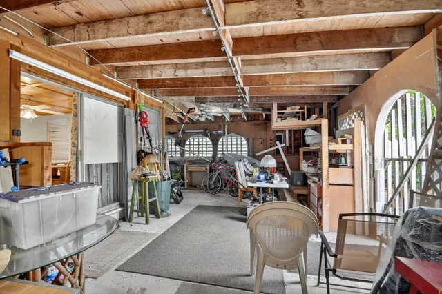 an aerial view of residential houses with outdoor space and trees