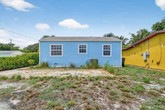 a living room with furniture and a flat screen tv with wooden floor