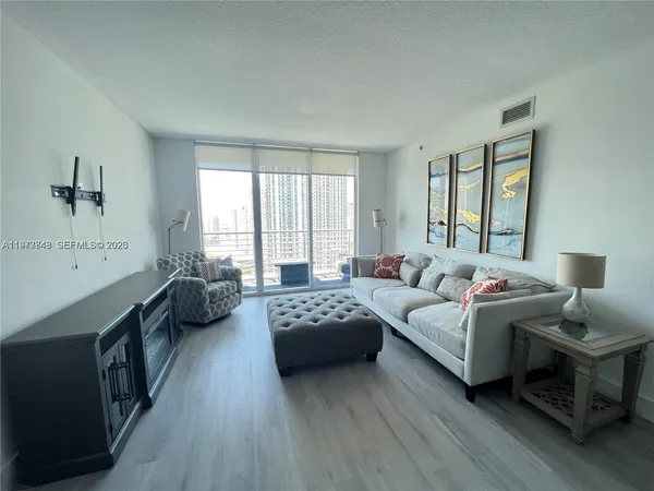 a spacious bedroom with a bed couch and a window