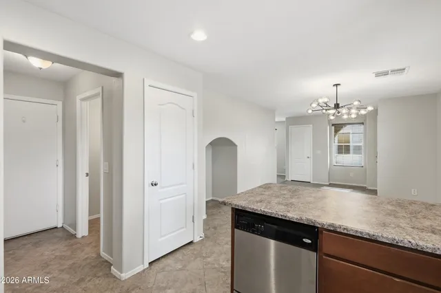a kitchen with a sink and chandelier