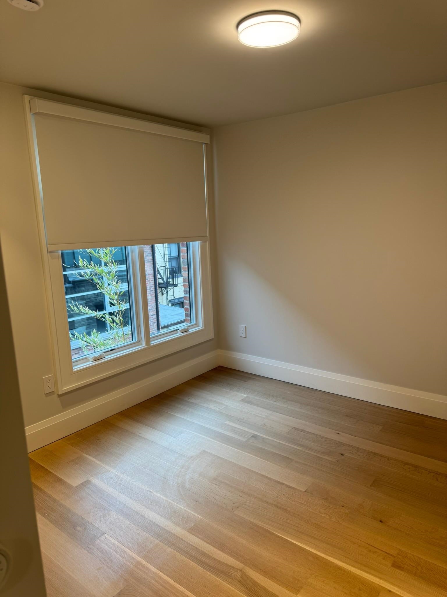 625 Court Street Hoboken, NJ 07030 - Photo 11 of 14 a view of an empty room with a window