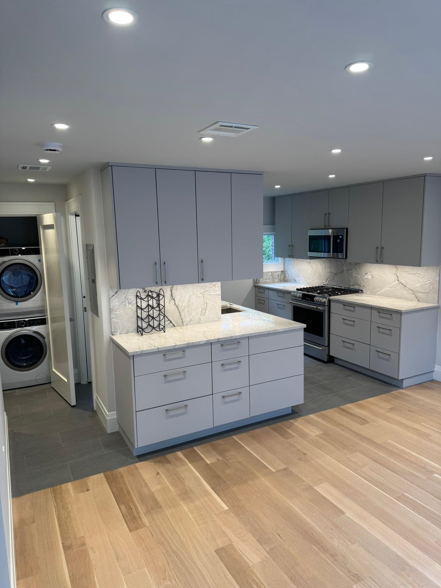 625 Court Street Hoboken, NJ 07030 - Photo 3 of 14 a large kitchen with stainless steel appliances granite countertop a stove and a sink