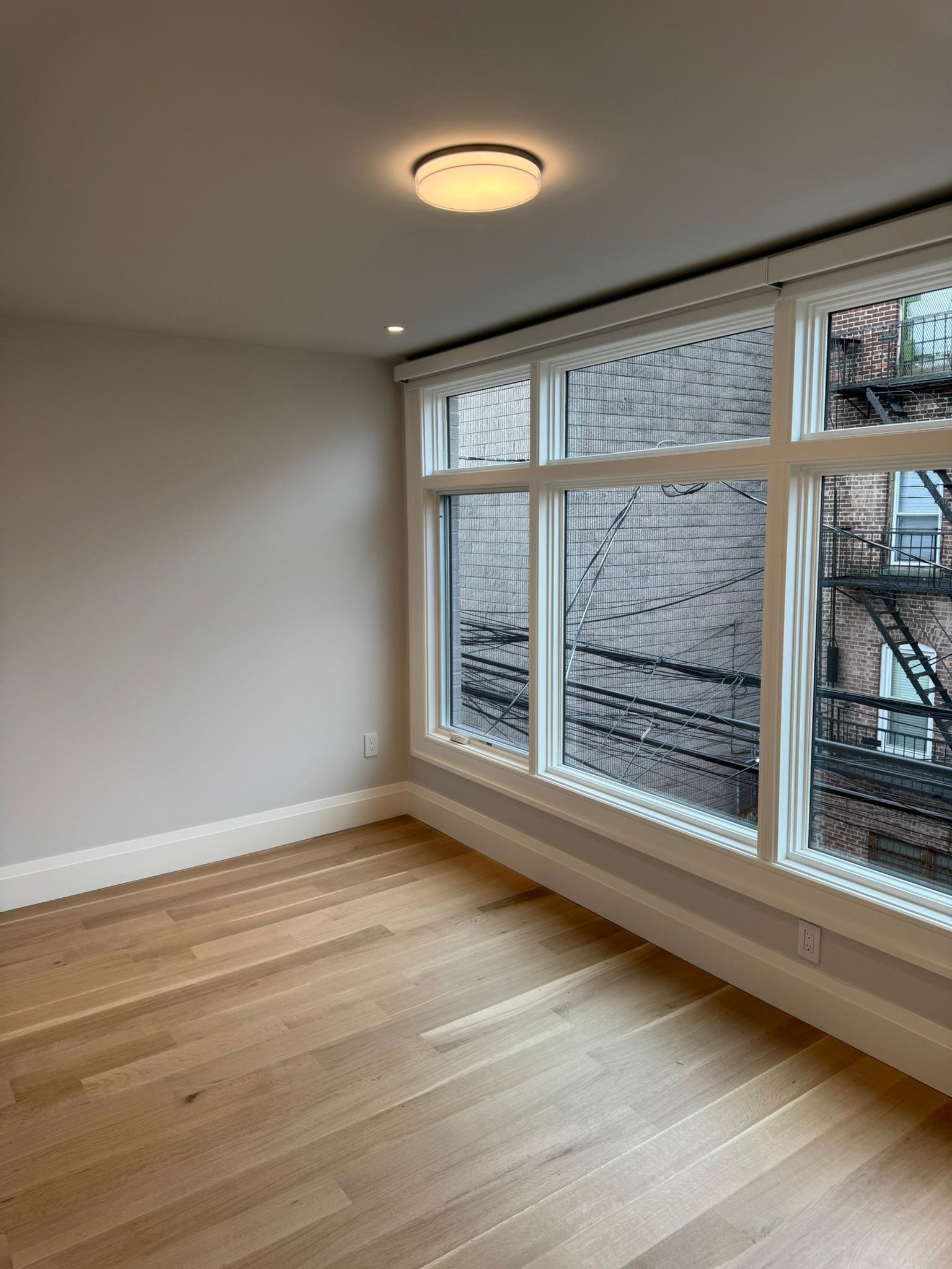 625 Court Street Hoboken, NJ 07030 - Photo 4 of 14 a view of an empty room with a window