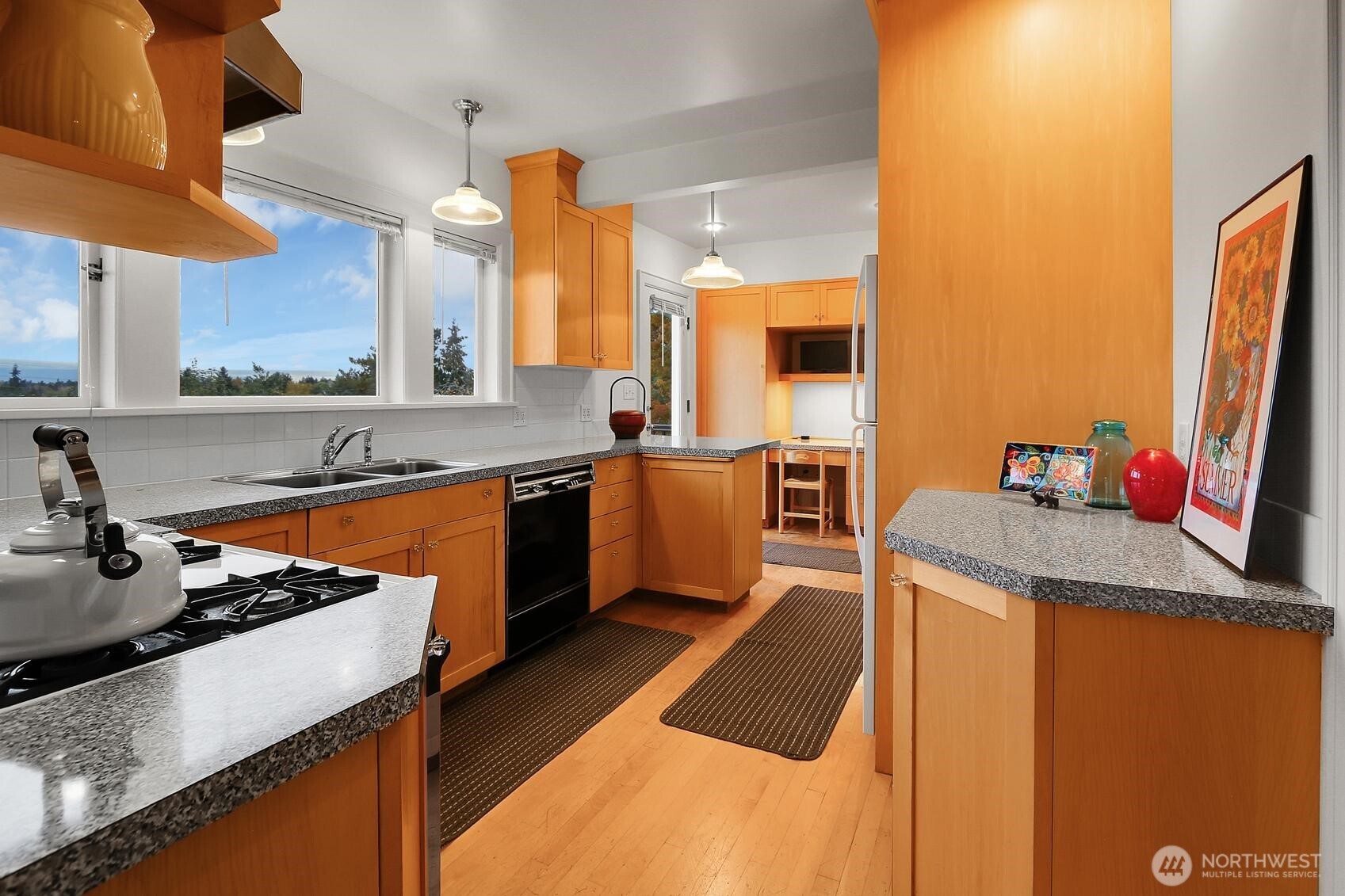 6535 Sycamore Avenue Northwest Seattle, WA 98117 - Photo 15 of 23 a kitchen with stainless steel appliances granite countertop a sink stove and refrigerator