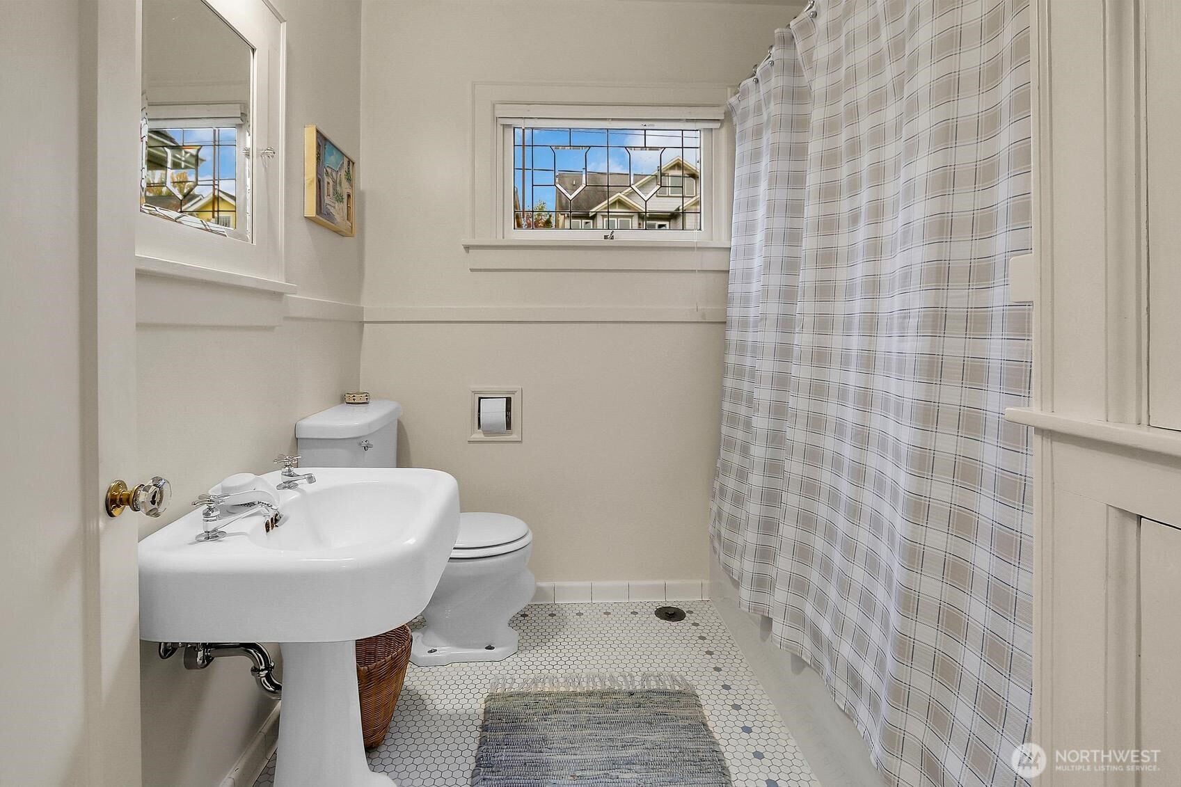 6535 Sycamore Avenue Northwest Seattle, WA 98117 - Photo 16 of 23 a bathroom with a sink a toilet and shower