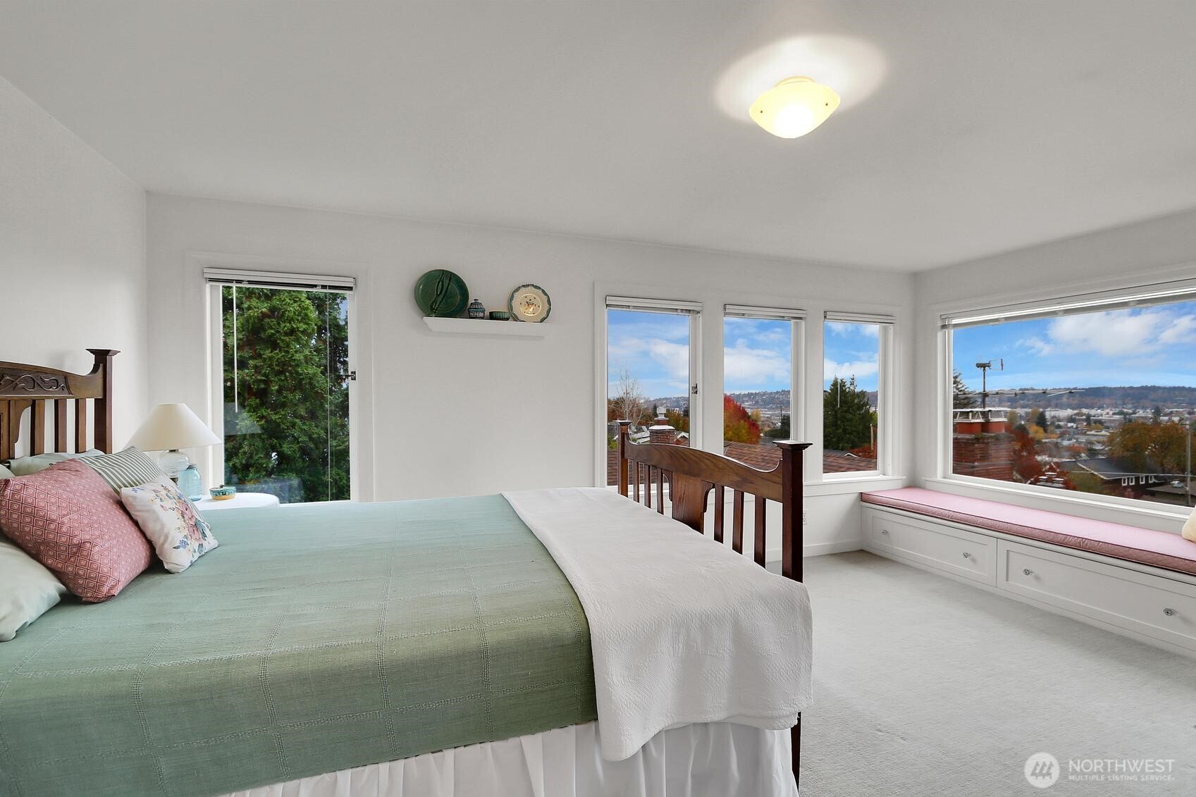 6535 Sycamore Avenue Northwest Seattle, WA 98117 - Photo 7 of 23 a bedroom with a large bed and a large window