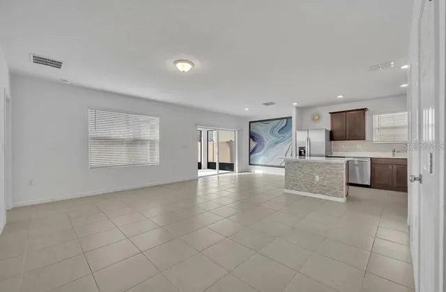 a view of kitchen with furniture and flat screen tv