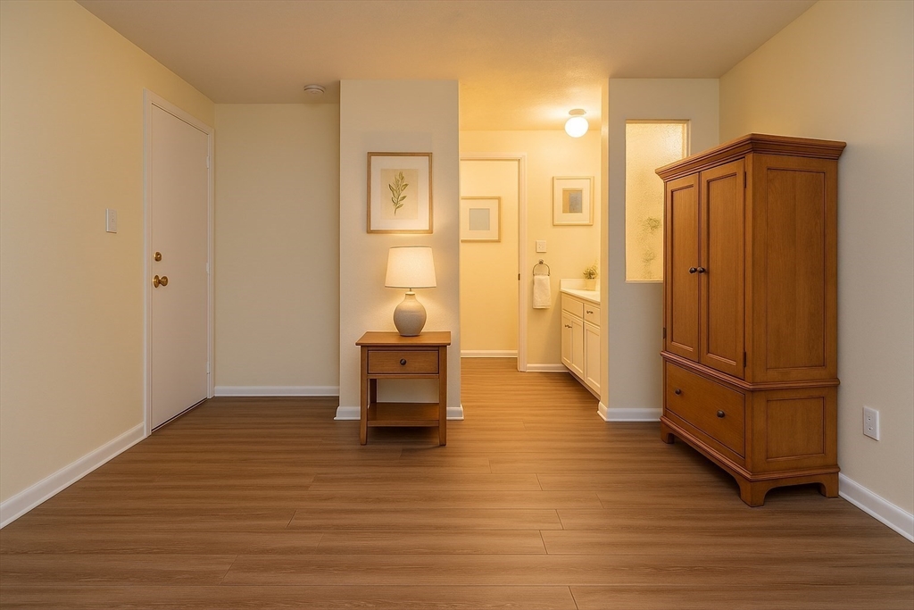 915 Edgell Road, Unit 85 Framingham, MA 01701 - Photo 7 of 16 a view of a hallway with wooden floor and furniture