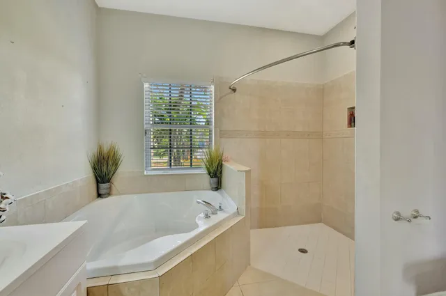 a bathroom with a tub and shower