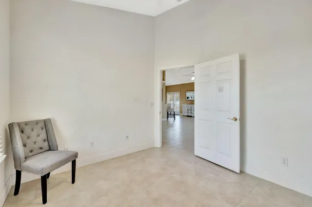 a view of a room with a hallway and a chair