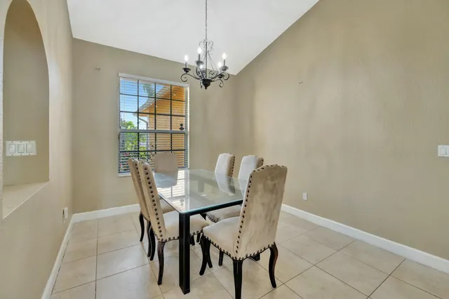 a view of a dining room with furniture and chandelier