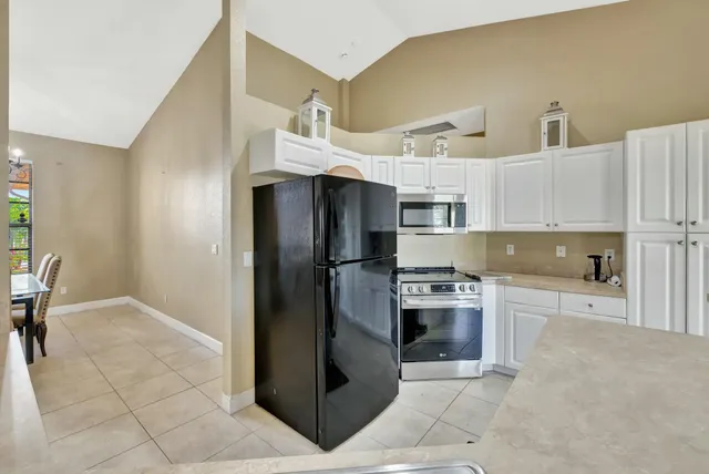 a kitchen with stainless steel appliances a stove a sink and a refrigerator