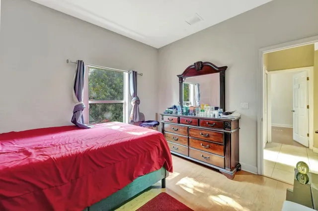 a bedroom with a bed and a dresser in it