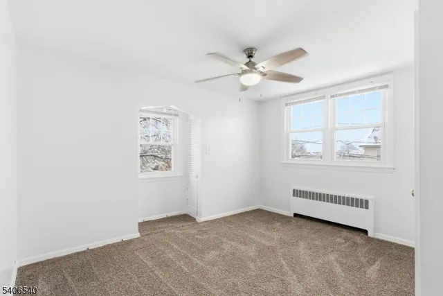 a view of room with window and ceiling fan
