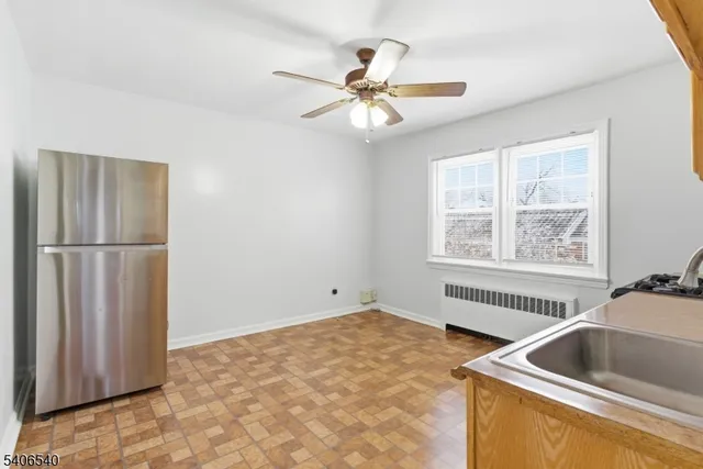 a kitchen with a refrigerator sink and cabinets