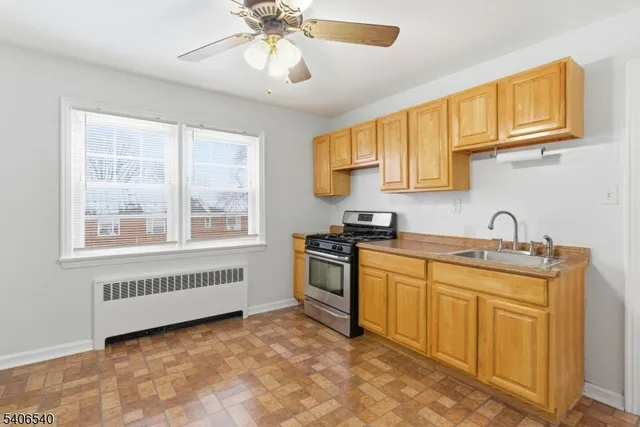 a kitchen with stainless steel appliances granite countertop a sink and cabinets