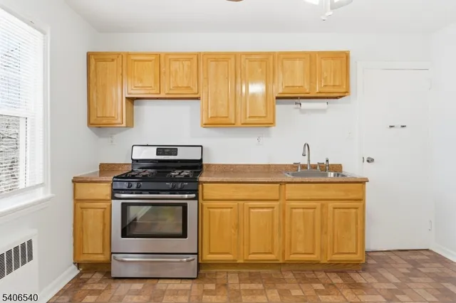 a kitchen with stainless steel appliances granite countertop a sink and a stove
