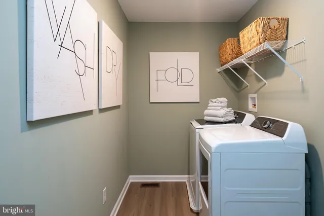 a bathroom with a granite countertop sink a toilet and a large mirror