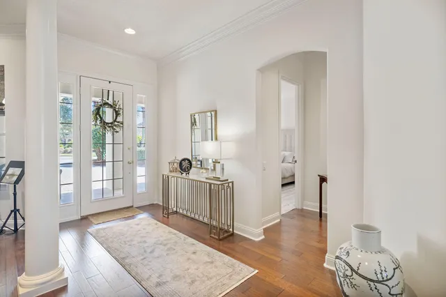 a large kitchen with cabinets wooden floor white stainless steel appliances and dining table