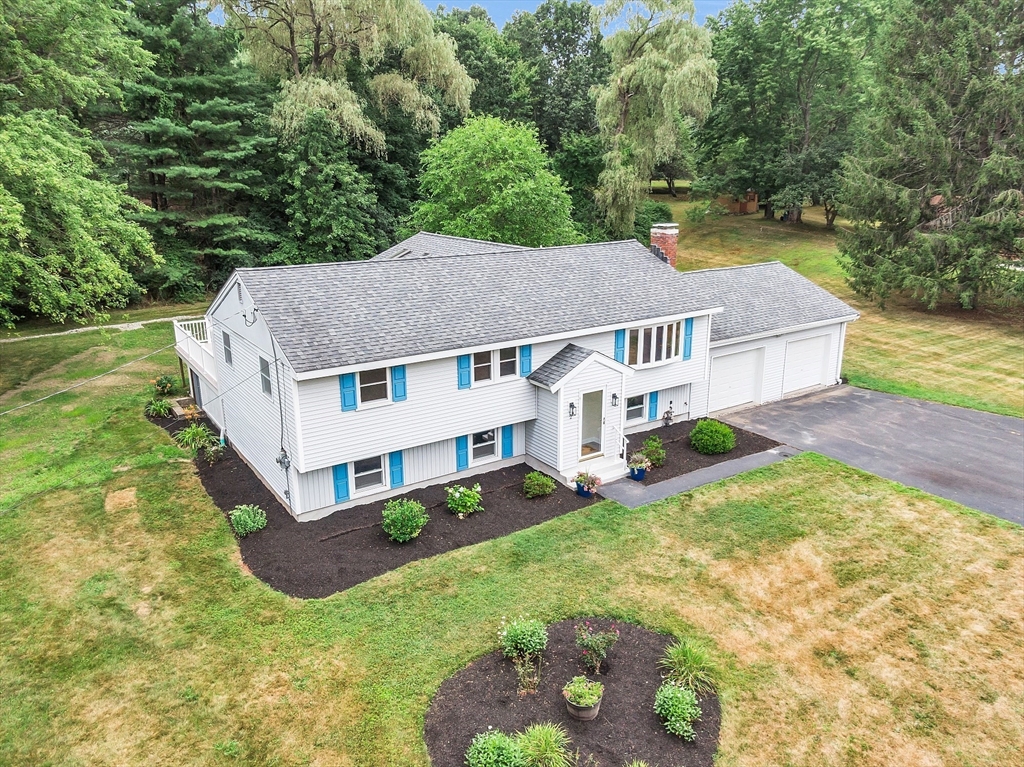 an aerial view of a house with a yard table and chairs