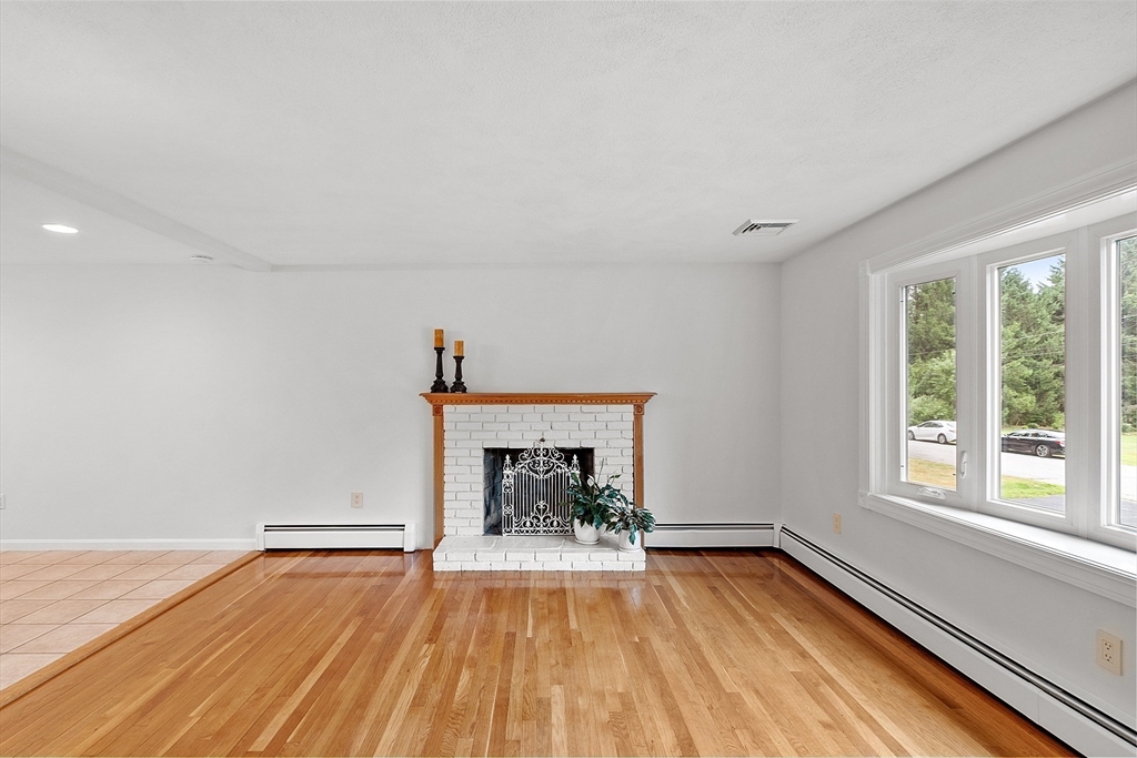 2 Johnson Road Chelmsford, MA 01824 - Photo 14 of 42 a view of empty room with wooden floor and fireplace