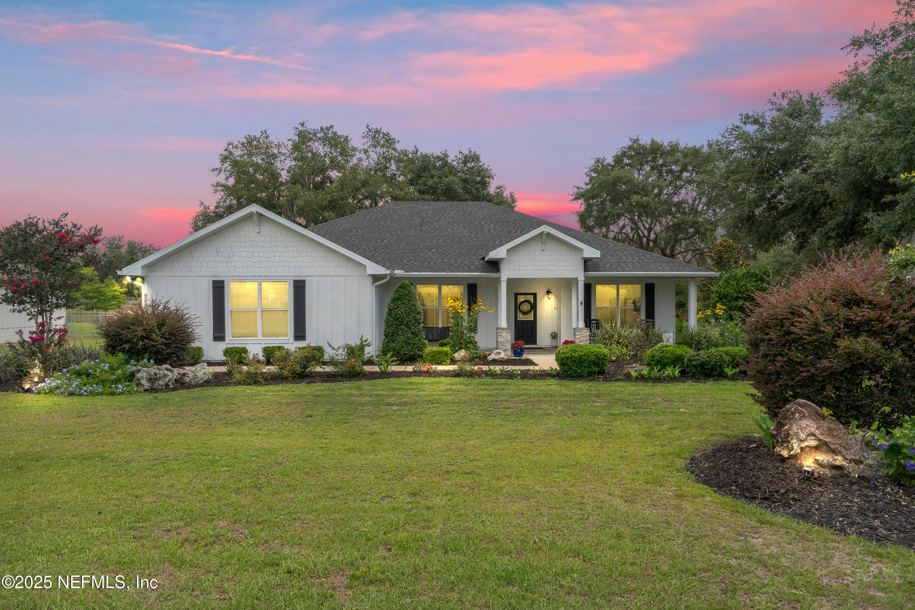 a front view of a house with swimming pool having outdoor seating