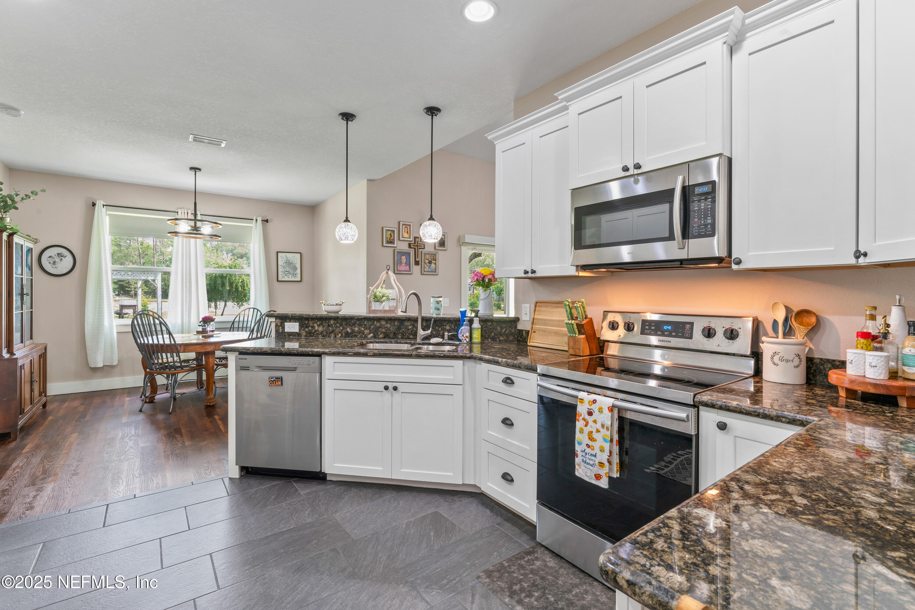 6228 Blue Marlin Drive Keystone Heights, FL 32656 - Photo 25 of 45 a kitchen with stainless steel appliances granite countertop a stove top oven a sink dishwasher and a microwave oven with white cabinets