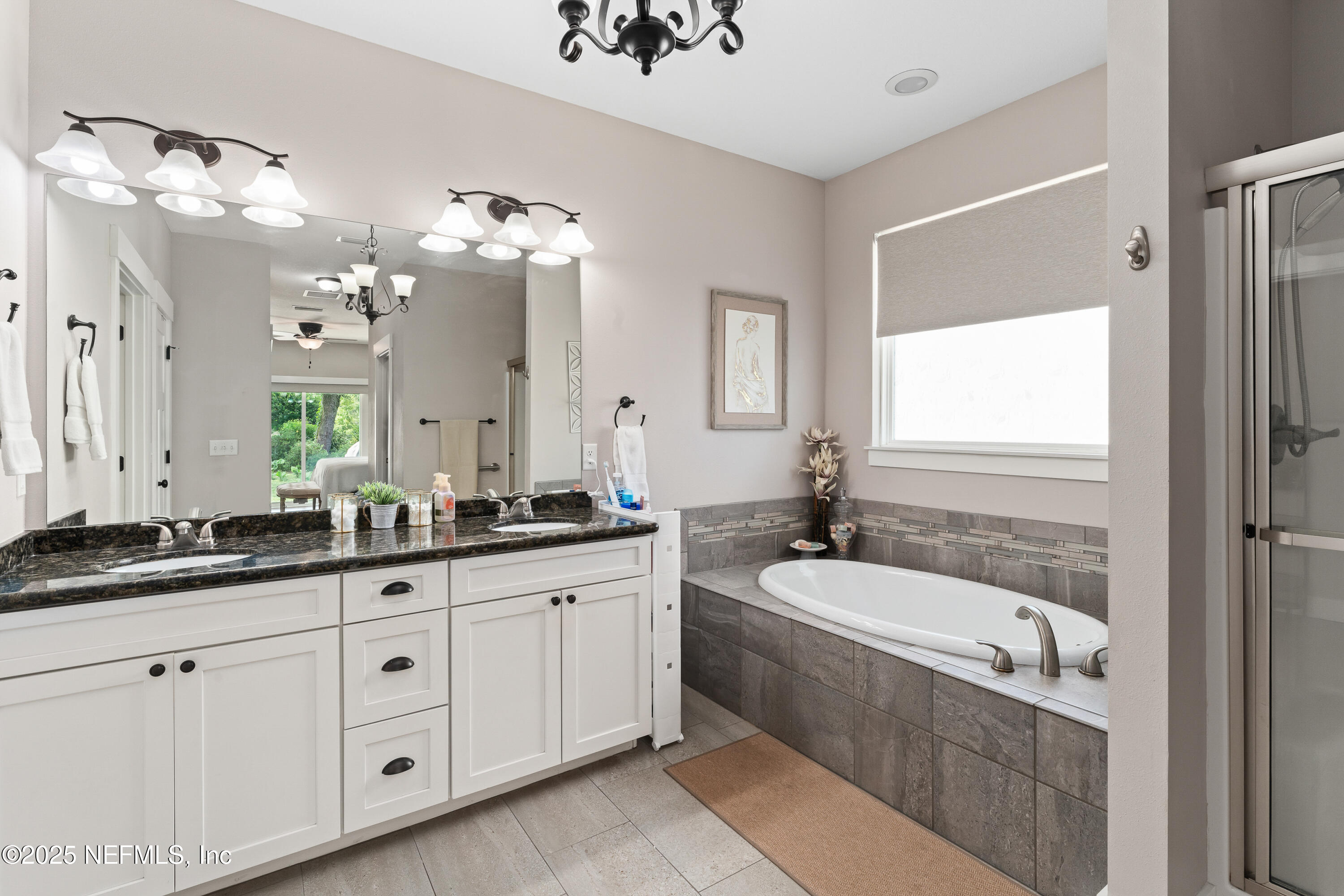 6228 Blue Marlin Drive Keystone Heights, FL 32656 - Photo 31 of 45 a bathroom with a granite countertop bathtub a double vanity sink a vanity a window and a mirror