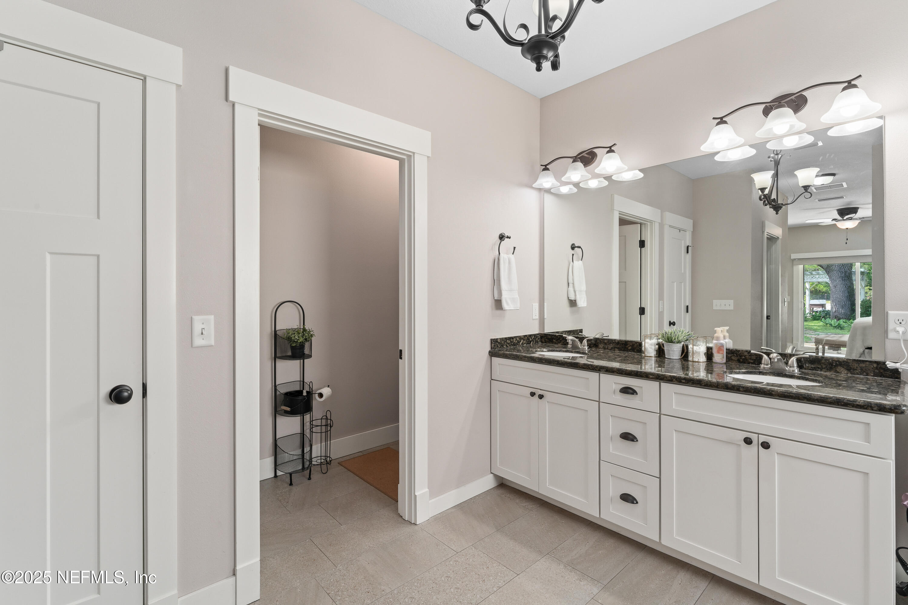 6228 Blue Marlin Drive Keystone Heights, FL 32656 - Photo 33 of 45 a spacious bathroom with a granite countertop sink a mirror and a shower