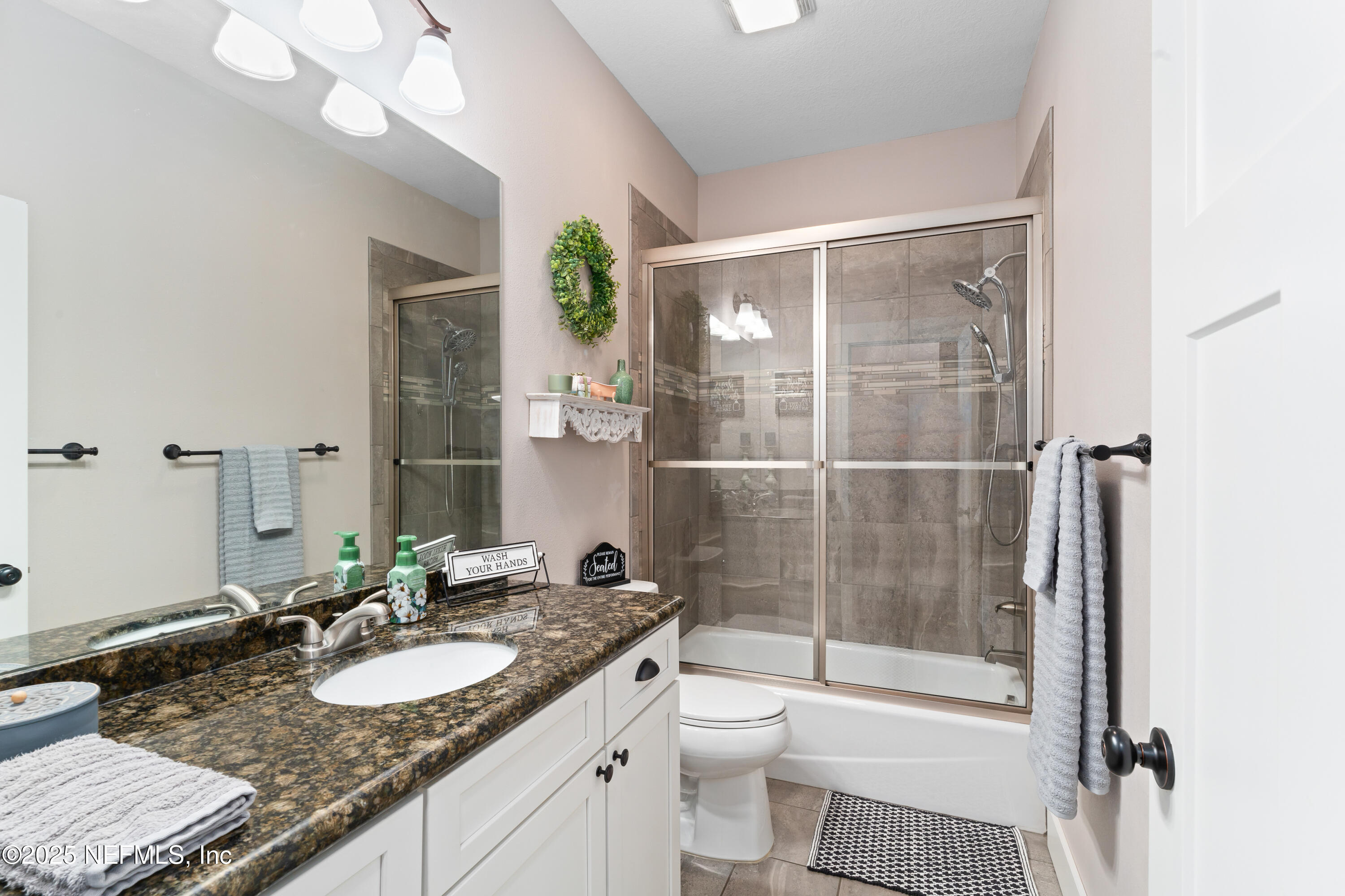 6228 Blue Marlin Drive Keystone Heights, FL 32656 - Photo 41 of 45 a bathroom with a granite countertop sink toilet and shower