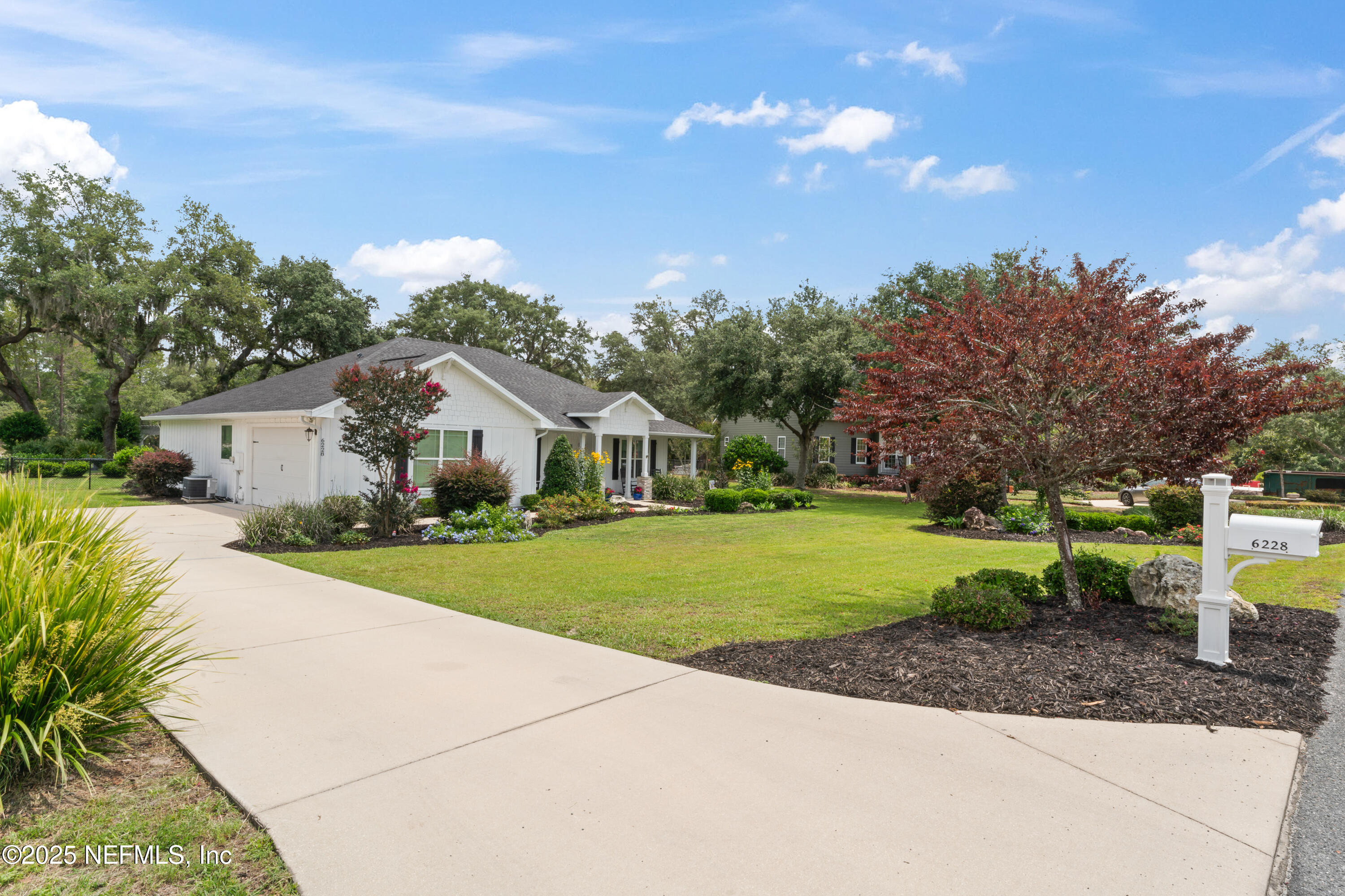 6228 Blue Marlin Drive Keystone Heights, FL 32656 - Photo 5 of 45 a front view of a house with a yard and trees