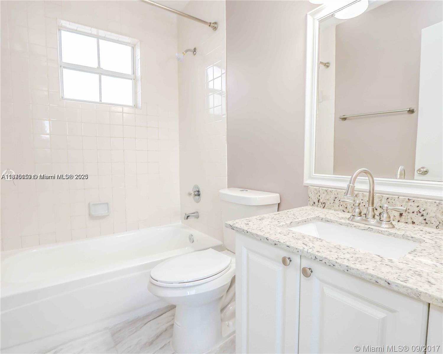 8734 Southwest 3rd Street, Unit 206 Pembroke Pines, FL 33025 - Photo 13 of 14 a bathroom with a granite countertop sink toilet and shower