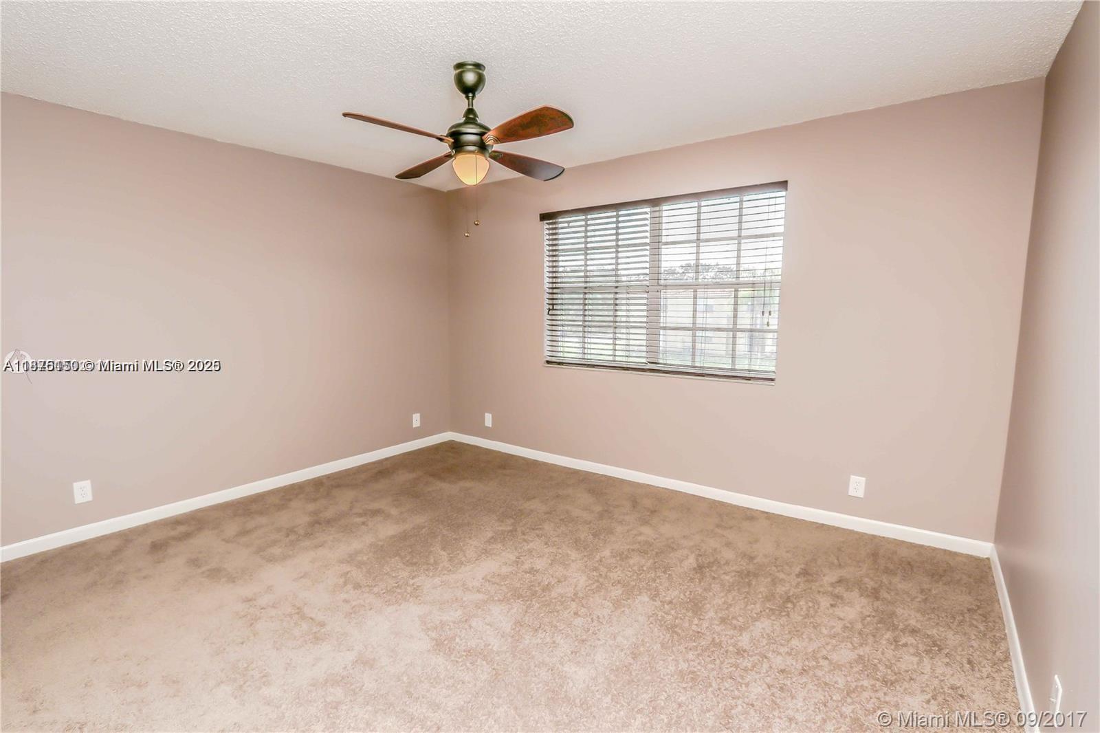 8734 Southwest 3rd Street, Unit 206 Pembroke Pines, FL 33025 - Photo 9 of 14 a view of an empty room with a window