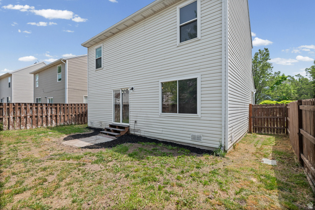 1346 Archmore Drive Springville, UT 84663 - Photo 26 of 32 Rear exterior featuring light-colored horizontal siding, a sliding glass door, and a ground-level concrete patio
