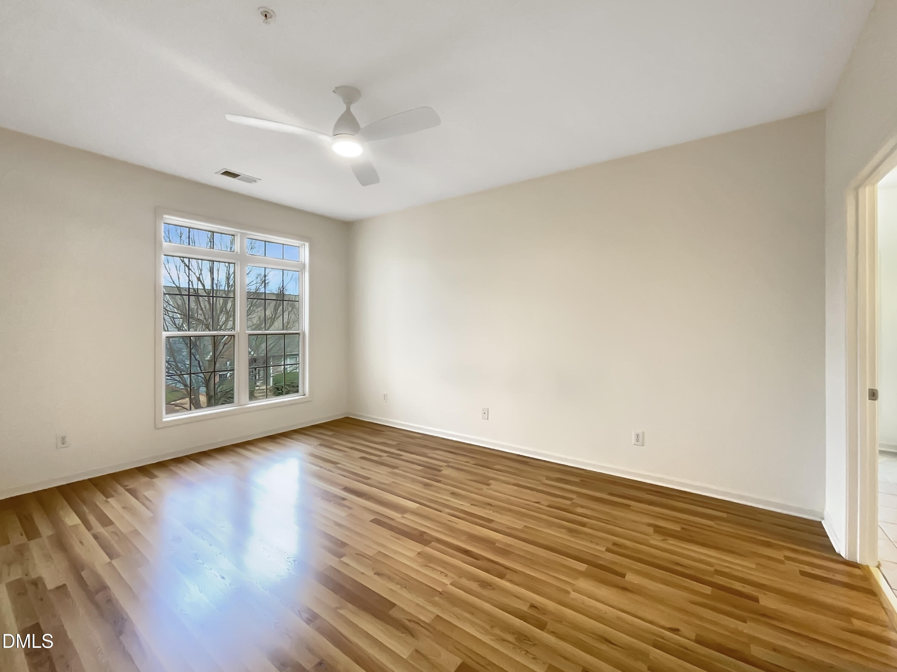 2501 Huntscroft Lane, Unit 203 Raleigh, NC 27617 - Photo 10 of 16 wooden floor in an empty room with a window
