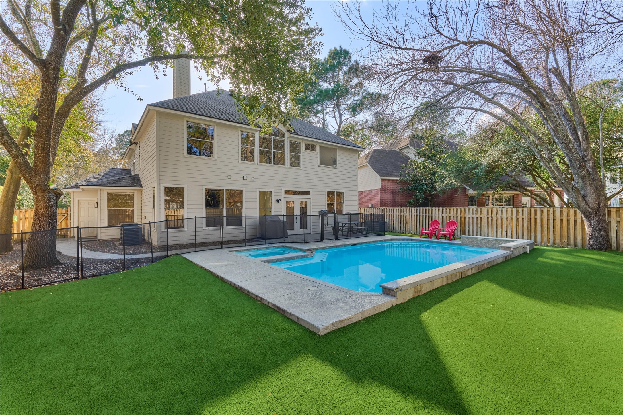 58 South Bethany Bend Circle Spring, TX 77382 - Photo 2 of 45 Sparkling backyard oasis with pool & spa surrounded by artificial turf for year-round, easy maintenance, and color!