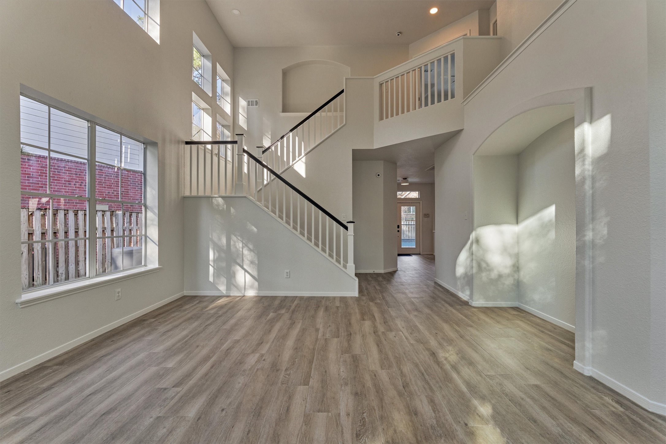 58 South Bethany Bend Circle Spring, TX 77382 - Photo 4 of 45 Step inside to a freshly painted interior, soaring sightlines, and wood-look tile flooring throughout! BETTER than new because you're in the heart of The Woodlands - low tax rate, and no HOA dues!