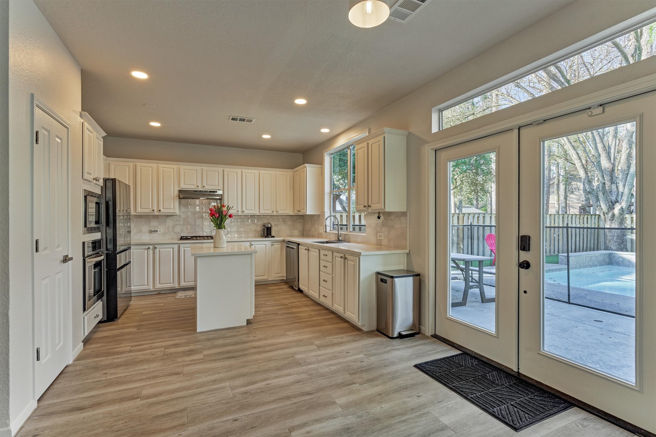 58 South Bethany Bend Circle Spring, TX 77382 - Photo 9 of 45 Double doors leading out to the sparkling pool and spa! Note: there's room to add a breakfast table here.