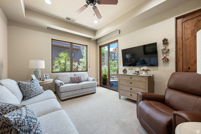 2331 West Entrada Trail, Unit 61 St. George, UT 84770 - Photo 22 of 69 Spacious room featuring carpeted flooring, a ceiling fan, recessed lighting, and a tray ceiling