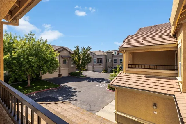 a view of a livingroom with wooden floor and a fireplace