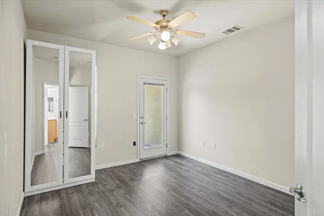 a view of empty room with wooden floor and fireplace